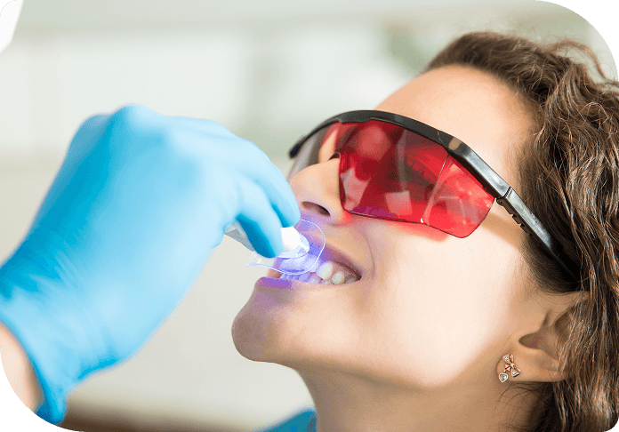 closeup-young-woman-having-her-teeth-whitened-with-ultraviolet-light-dental-clinic.png